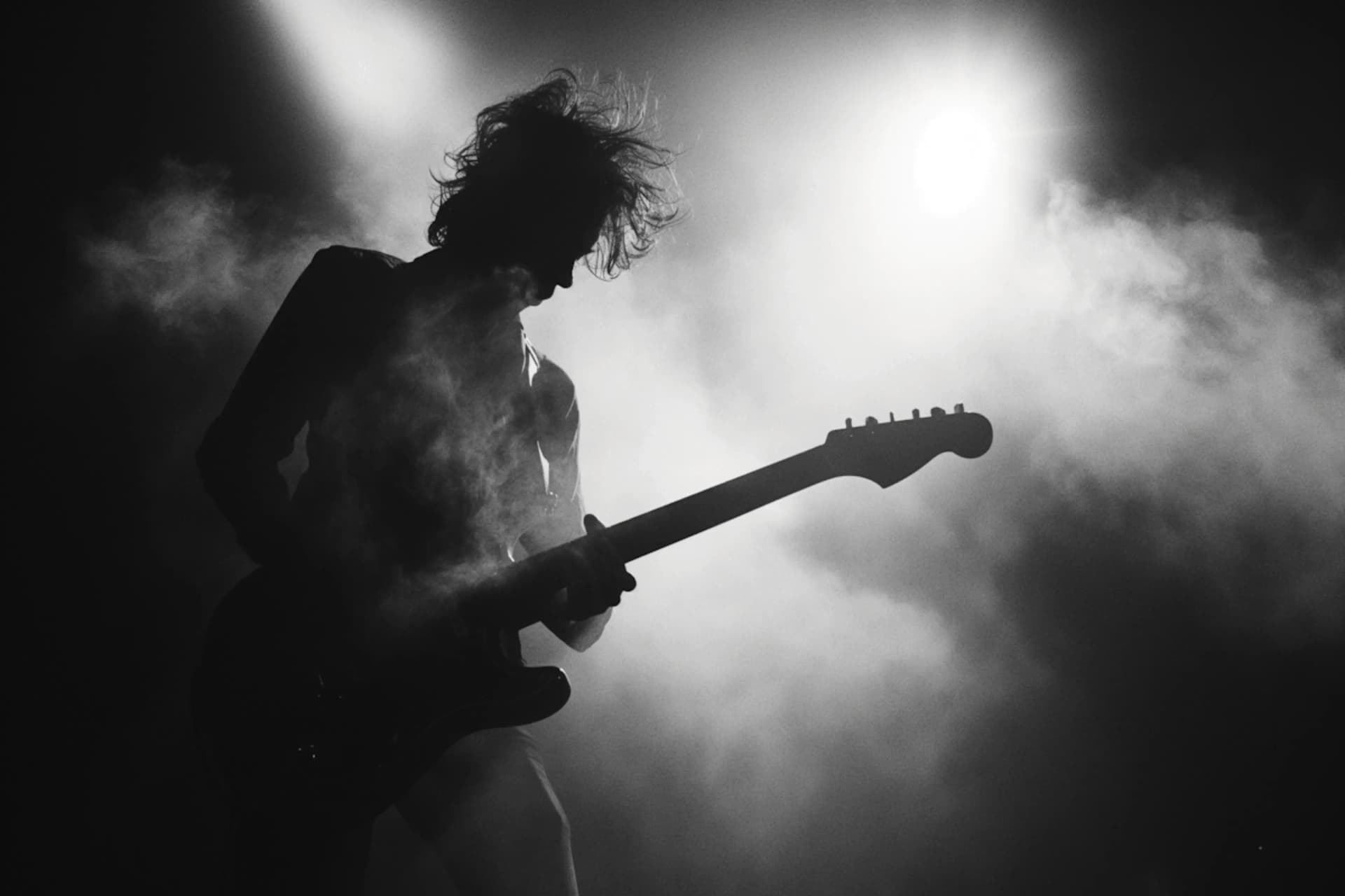 Artist performing with a guitar